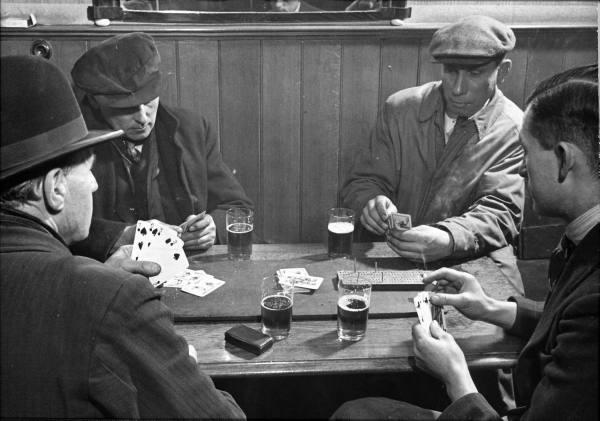 Black and white image of poker players in a bar